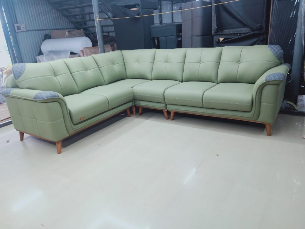 Deep cleaning a sofa with a handheld brush cleaner