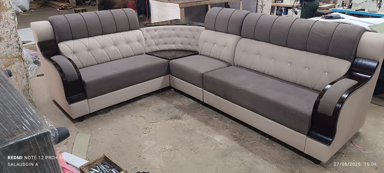Old torn fabric being replaced on a sofa